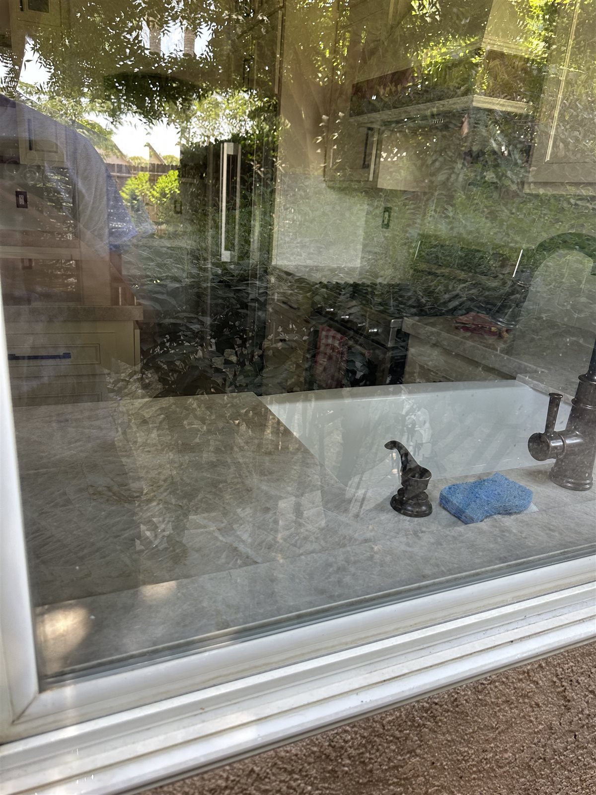 Same sliding glass door crystal clear after hard water stain removal by Rynse Cleaning