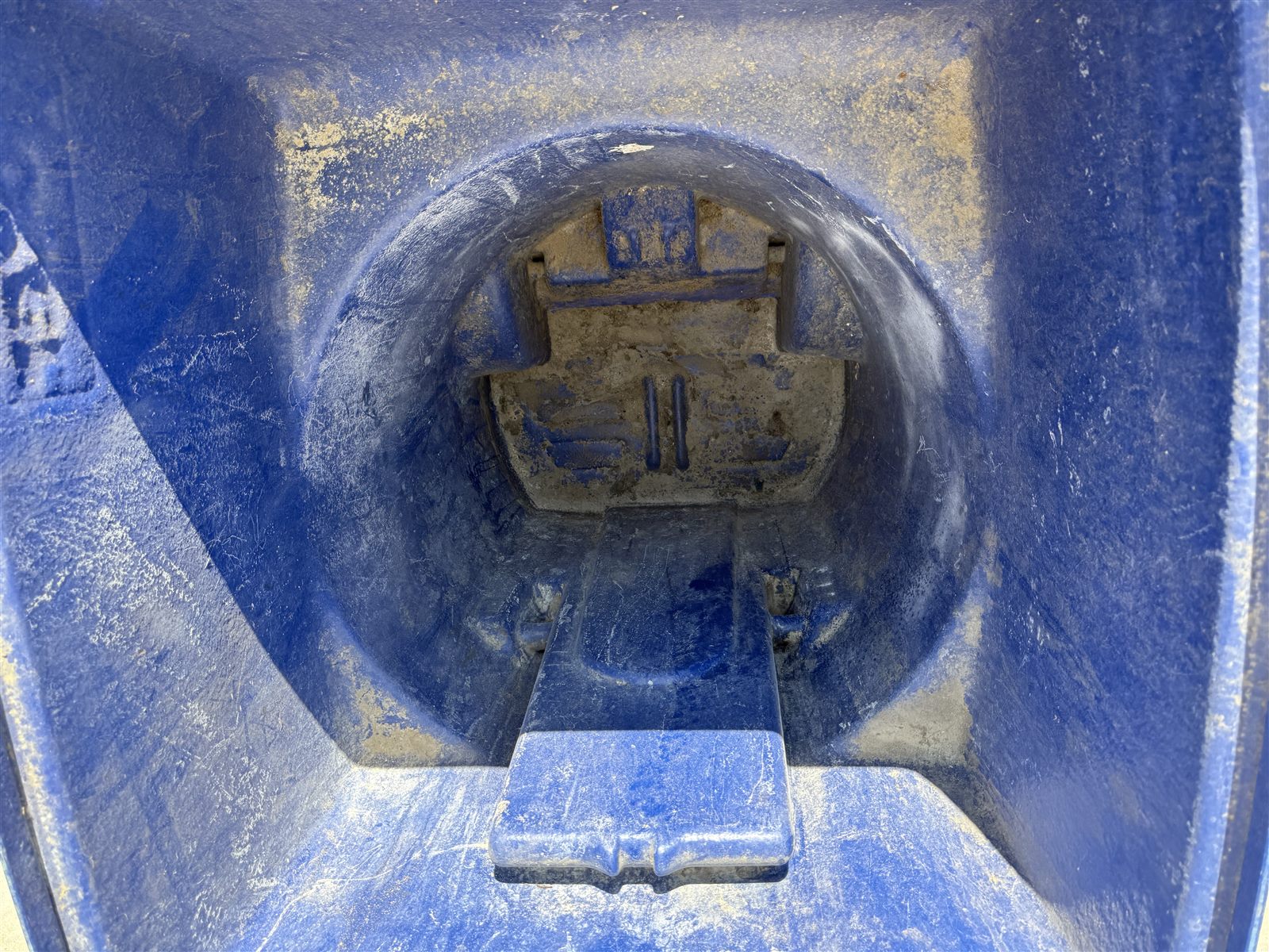 Inside of a residential trash can caked with grime before cleaning