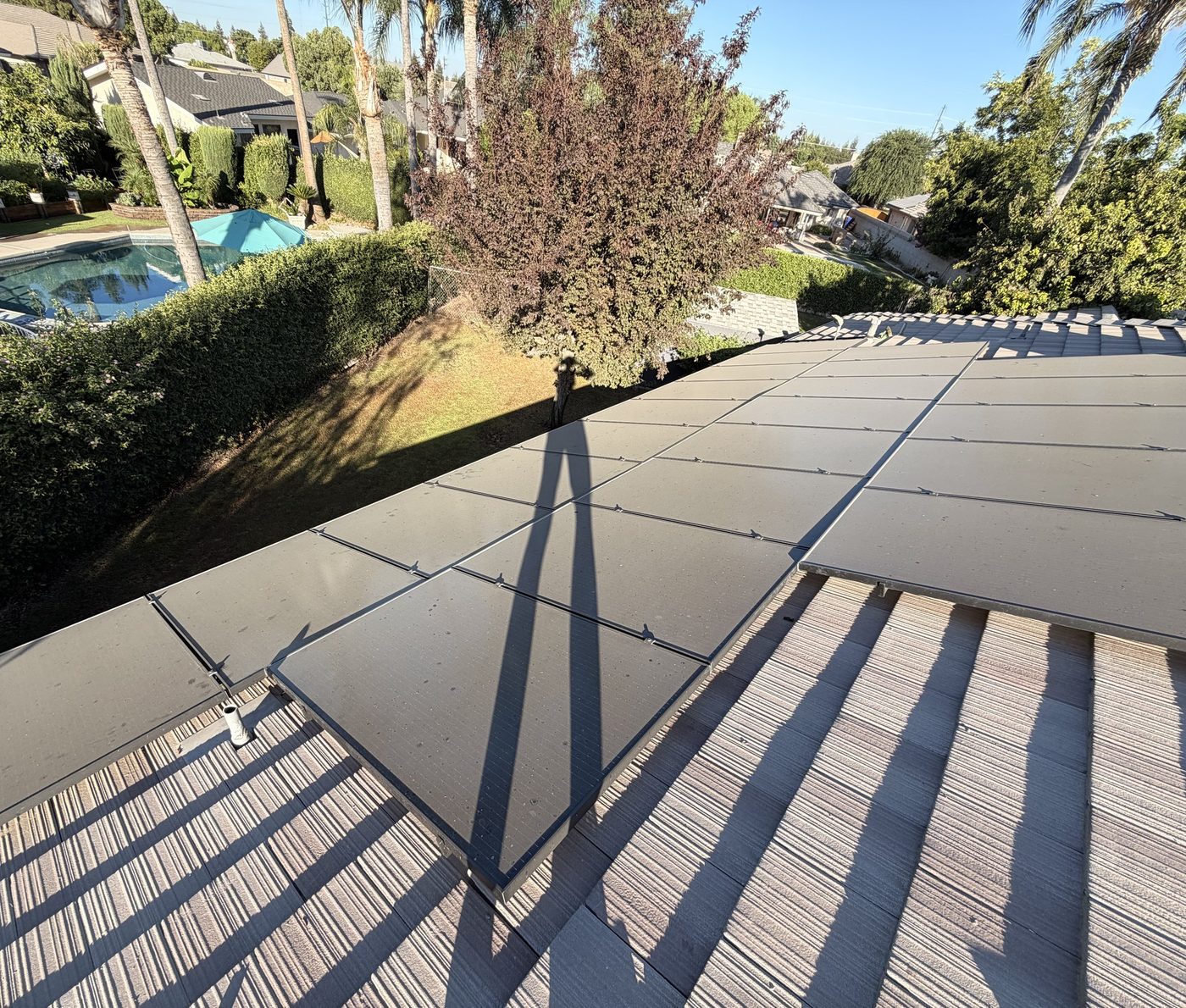 Rooftop solar panels coated in Bakersfield dust before cleaning