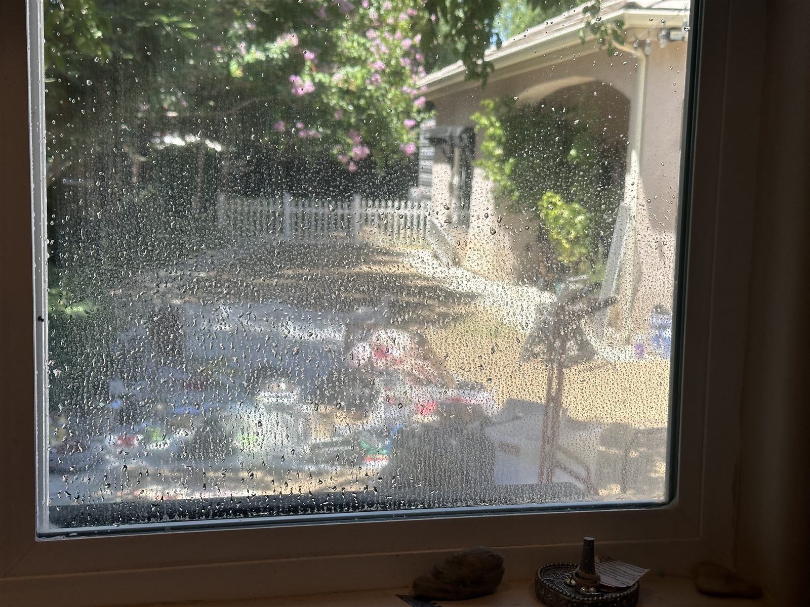 Front window covered in water spots and dust before cleaning — Bakersfield home